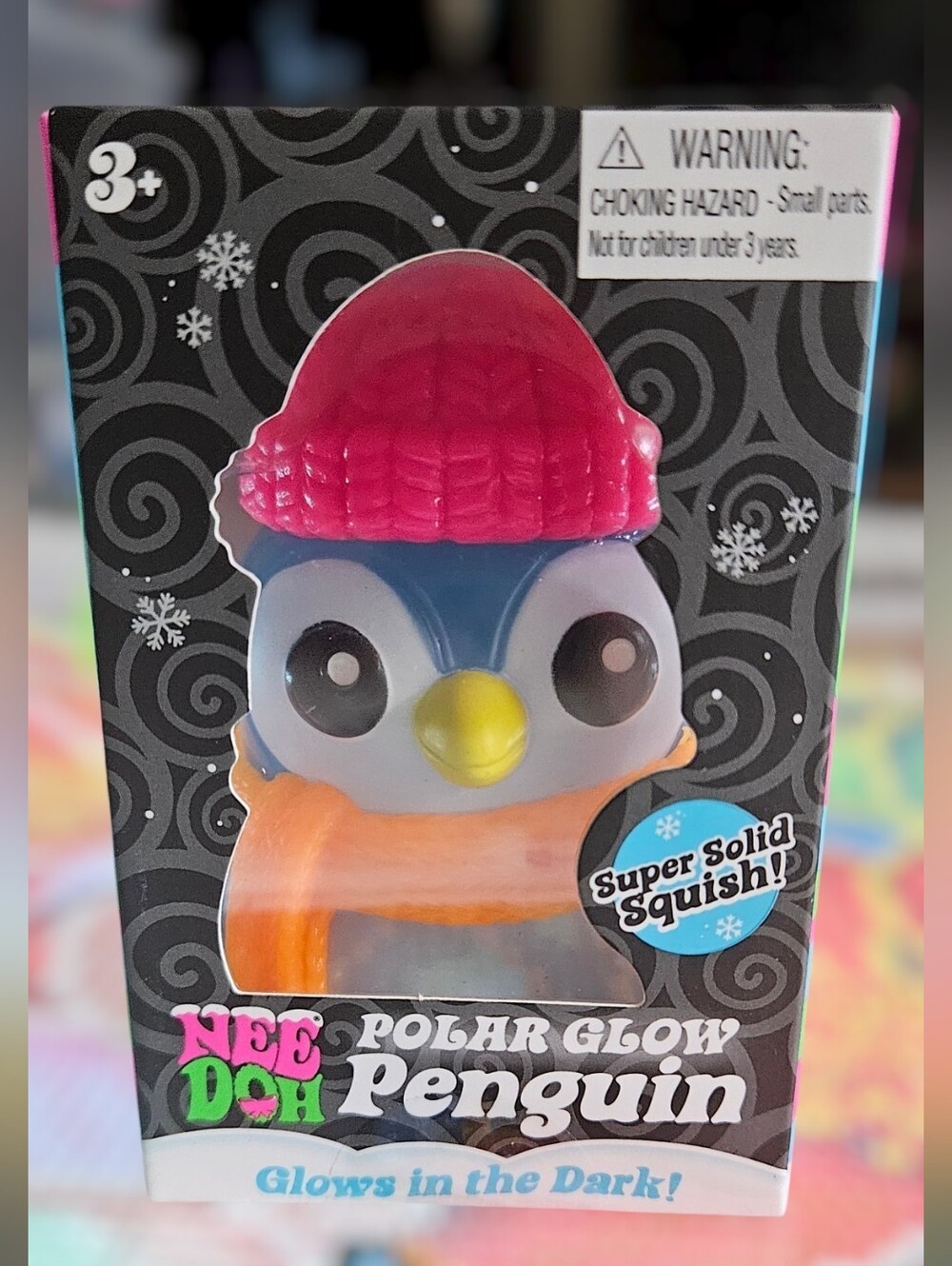 NeeDoh Polar Glow Penguin Squishy Toy - Blue Body, Pink Hat, Orange Scarf